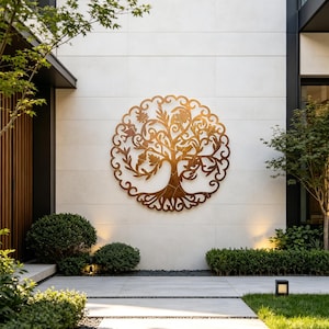 May include: A circular metal wall art piece featuring an intricate, laser-cut design of a tree with sprawling branches, detailed leaves, and a thick trunk, finished in a warm, metallic bronze tone, mounted centrally on a light-colored stone wall.