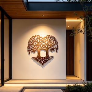 May include: A large, intricate metal wall art piece shaped like a tree with a heart-like silhouette. The sculpture features a textured, bronze-toned finish with detailed branches, leaves, and exposed roots, mounted centrally on a smooth white wall.