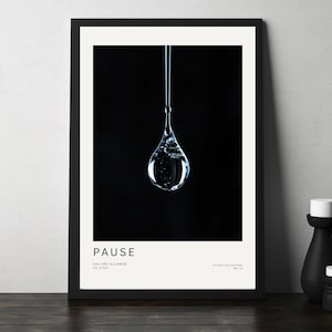 May include: A framed art print showing a water droplet against a black backdrop. The word "PAUSE" is printed at the bottom, with the text "YOU ARE ALLOWED TO STOP". The print is in a black frame and is part of the "STUDIO COLLECTION NO. 11".