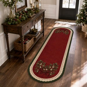 May include: An oval-shaped runner rug featuring a deep red center with a dark green border and a cream-colored lace-style trim. The rug displays a symmetrical design of green mistletoe sprigs with white berries and a red bow at both ends.