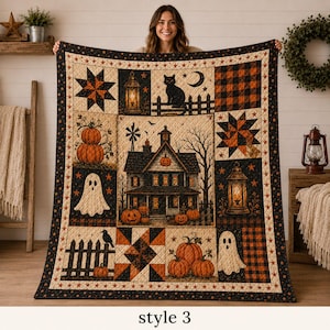 May include: A rectangular Halloween-themed quilt featuring a central haunted house illustration surrounded by blocks of pumpkins, ghosts, a black cat, lanterns, stars, and orange and black plaid patterns, all framed by a border of small stars.