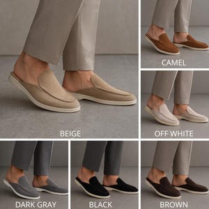May include: A collection of suede slip-on mules in various colors: beige, camel, off-white, dark gray, black, and brown. Each pair features a rounded toe and a contrasting white sole. The image showcases the shoes on a person's feet.