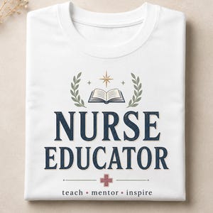 May include: White t-shirt with the words "NURSE EDUCATOR" in navy blue, with a cross symbol and the words "teach • mentor • inspire" below. The design includes a book, star, and laurel wreath.