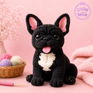 May include: A black crochet French Bulldog with pink inner ears and a white chest patch. The dog has large eyes and a pink tongue. A basket of yarn balls and a crochet hook are in the background. The text "Crochet faticie" is in the upper right corner.