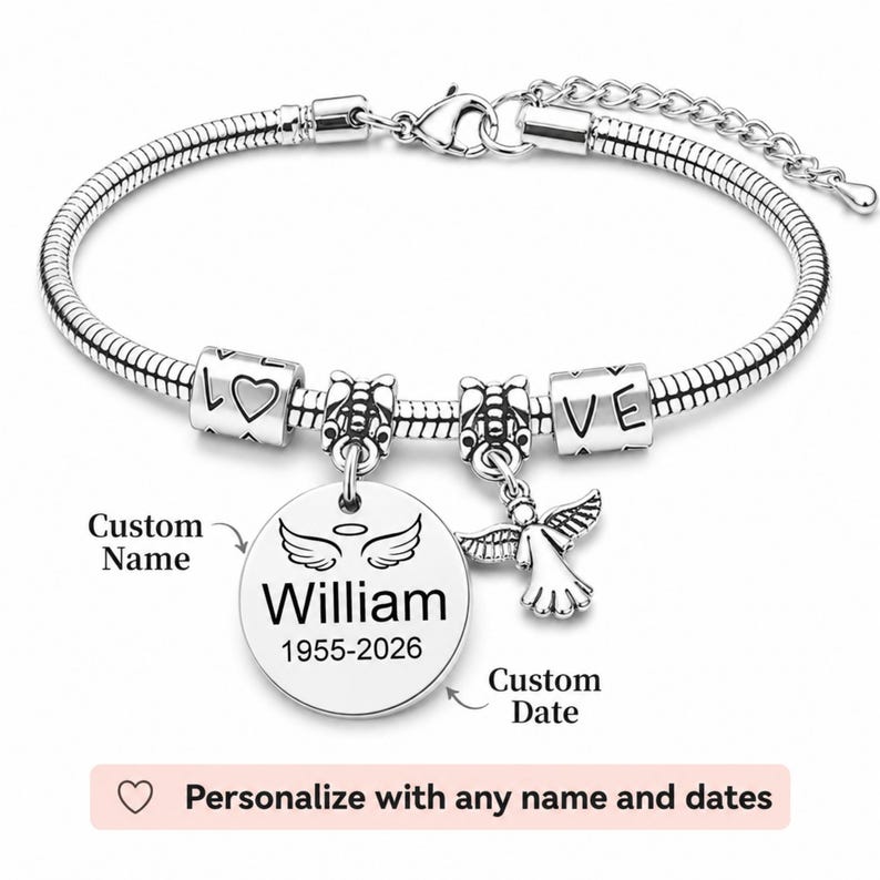 May include: A silver bracelet with a snake chain. It has charms spelling "LOVE", a heart, and an angel pendant. A round charm is engraved with the name "William" and dates "1955-2026".