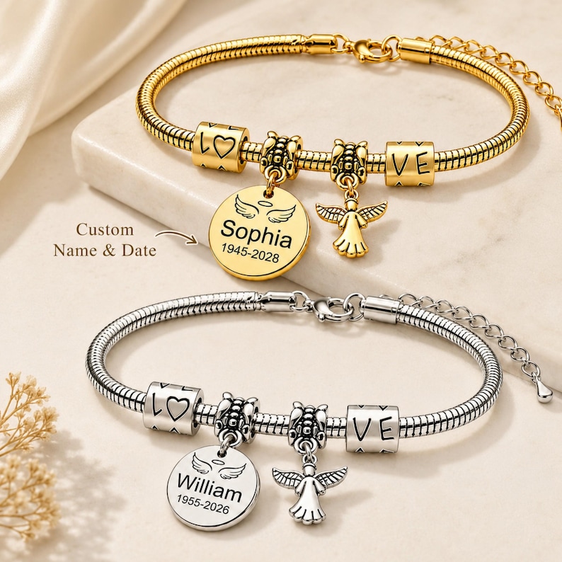 May include: Two personalised charm bracelets. One gold-toned with a round charm engraved with "Sophia" and dates, and an angel charm. The other is silver-toned with "William" and dates, and an angel charm. Both have "LOVE" and heart charms.