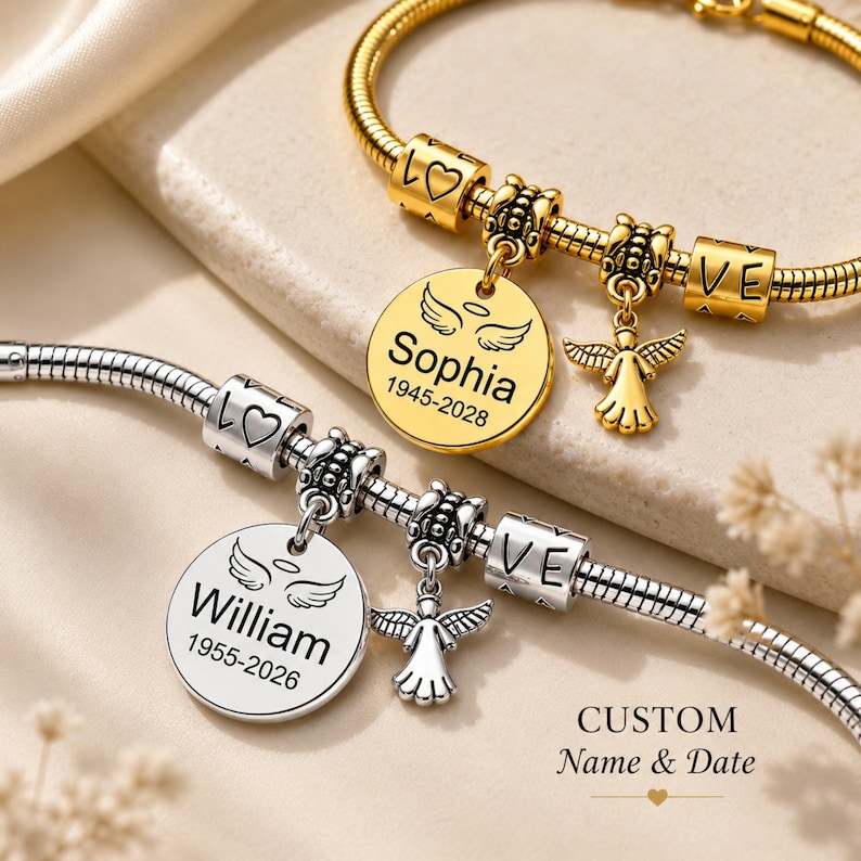 May include: Two personalised charm bracelets. One gold-toned with a round charm engraved with "Sophia" and dates, and a small angel charm. The other is silver-toned with a similar charm engraved with "William" and dates, and an angel charm.