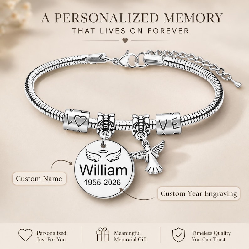 May include: A silver charm bracelet featuring a personalized pendant engraved with the name "William" and dates "1955-2026". The bracelet includes charms with the word "LOVE" and an angel charm. The text "A PERSONALIZED MEMORY THAT LIVES ON FOREVER" is at the top.