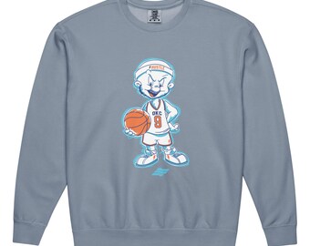 May include: A slate blue crewneck sweatshirt featuring a cartoon character wearing a white headband with the text HUSTLE and a white basketball jersey with OKC 9 printed on the front. The character holds an orange basketball.
