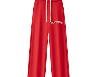 May include: Bright red sweatpants featuring a wide-leg silhouette, an elastic waistband with white drawstring cords, and the word WISCONSIN printed in white capital letters in an arched font on the upper right leg area.