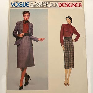 May include: Vintage Vogue American Designer sewing pattern featuring Calvin Klein designs. The cover shows two women modeling a skirt suit and a blouse with a plaid skirt. The pattern number is 2283.