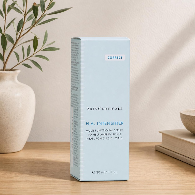 SkinCeuticals H.A. Intensifier serum box placed on a wooden table with soft lighting and minimalist home decor background