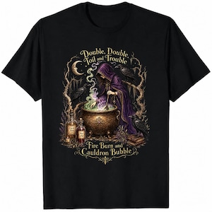 May include: A black t-shirt featuring a graphic of a hooded figure in a purple robe stirring a golden cauldron with green and purple smoke. The text reads Double, Double, Toil and Trouble and Fire Burn and Cauldron Bubble, surrounded by ravens, trees, and potion bottles.