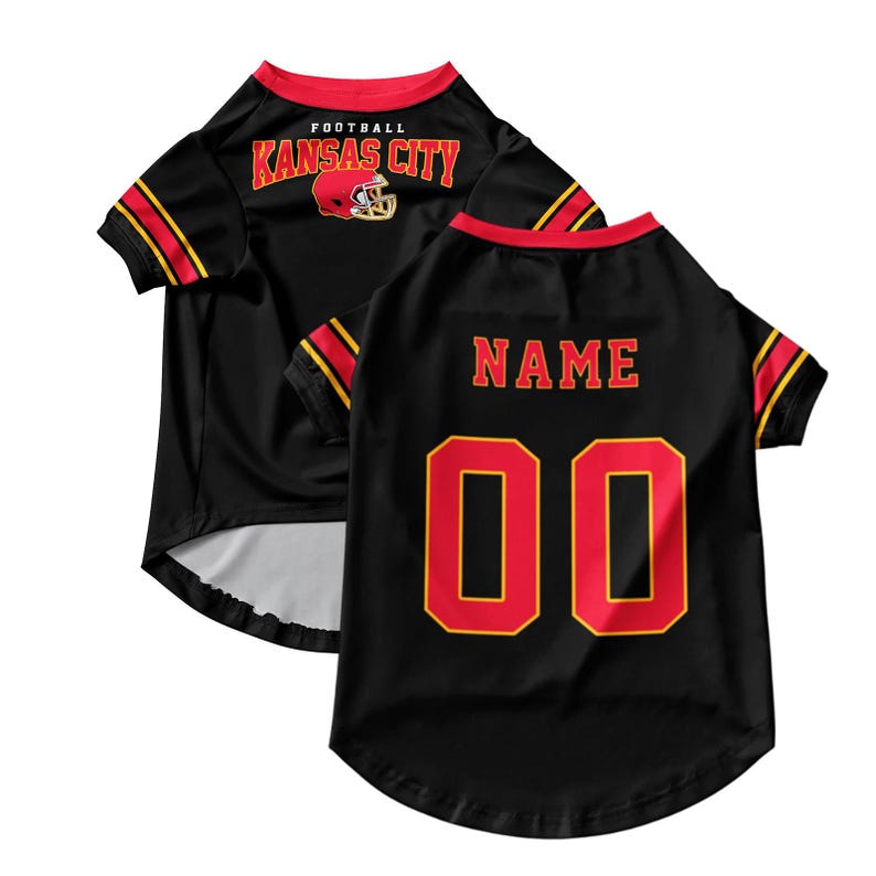 May include: Black pet jersey with red and gold accents. The front features "FOOTBALL KANSAS CITY" with a helmet graphic. The back displays "NAME" above the number "00" in red with a gold outline. The jersey has red trim.