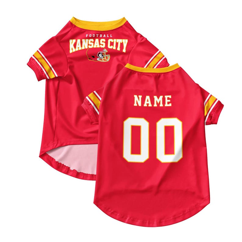 May include: Red pet jersey with yellow and white accents. The jersey features the text "KANSAS CITY" and a football helmet graphic on the back. The number "00" is displayed on the back, with space for a name.