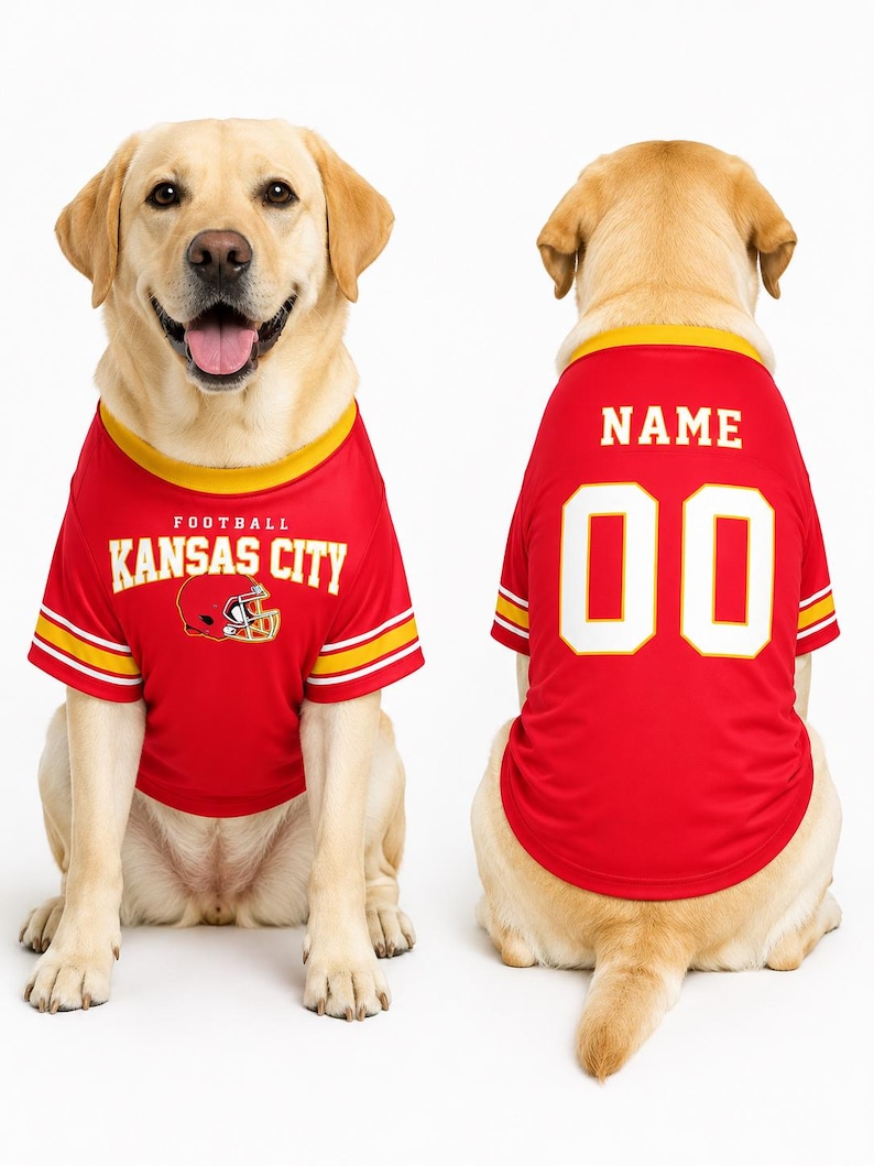 May include: Two dogs wearing red football jerseys. The front-facing dog's jersey reads "FOOTBALL KANSAS CITY" with a helmet graphic. The back-facing dog's jersey has "NAME" above the number "00". Both jerseys have yellow and white accents.
