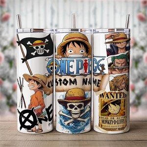 May include: Three white stainless steel tumblers with One Piece anime graphics. Designs include a pirate flag, Luffy, and other characters. Each tumbler has a silver straw and the text "ONE PIECE CUSTOM NAME" is visible.