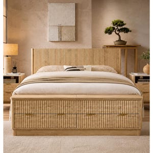 May include: A light-colored wooden bed frame with a vertically slatted headboard and a matching footboard with two drawers. The bed is made up with white bedding and a tan blanket. Two matching nightstands flank the bed.