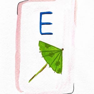 May include: Watercolor illustration featuring a blue letter "E" above a green cocktail umbrella with a floral pattern. The artwork is set within a white rectangle with a pink border and a black outline.