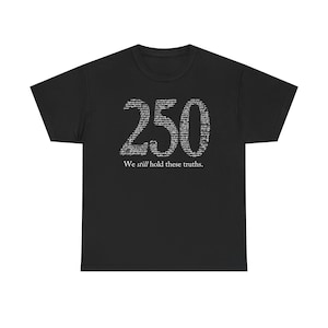 May include: Black t-shirt featuring the number "250" in a textured white font. Below the number is the text "We still hold these truths." This is a casual wear item.