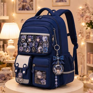 May include: A dark blue backpack featuring multiple exterior pockets, a white flap accent, and various anime-style character charms and pins attached to the front. The bag includes a mesh side pocket, adjustable shoulder straps, and zipper closures.