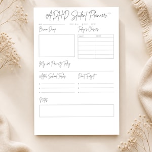 May include: A white ADHD Student Planner with handwritten-style text. The planner includes sections for a brain dump, today's classes, priority, after-school tasks, and notes. The planner is designed to help students with ADHD stay organized.