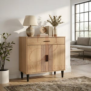 May include: A light oak wood sideboard featuring one top drawer and two cabinet doors with vertical slat detailing. The cabinet stands on four black tapered legs and includes a horizontal dark metal handle on the drawer and vertical handles.