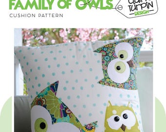 May include: A white cushion with a blue polka dot pattern featuring three appliquéd owls. The owls are green, brown, and yellow with white eyes and black pupils. The text "FAMILY OF OWLS CUSHION PATTERN" is at the top of the image. The text "claire turpin -DESIGN- " is in a tag at the top right of the image.