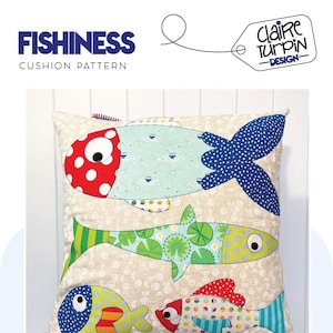 May include: A cushion cover with a patchwork design featuring four colourful fish. The fish are made from different fabrics with various patterns, including polka dots, stripes and floral prints. The cushion cover is beige with a subtle polka dot pattern.