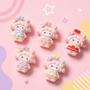 May include: Five small, pink doll figures with curly hair and floral headbands are arranged on a pink background. The dolls wear dresses in pastel colors, with details like bows and ruffles. The dolls have small, round eyes and rosy cheeks.