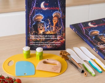 May include: A children's cookbook titled Die Mitternachtsküche with a yellow oval cutting board, two green shakers, a blue plastic scraper, a wooden dough cutter, metal tongs, and three plastic knives with green, blue, and yellow handles.