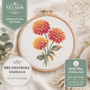 May include: A cross stitch pattern in a wooden embroidery hoop featuring three dahlias with orange and pink petals and green leaves on white fabric. The design is labelled Brushstroke Dahlias and measures 75 by 97 stitches in this digital download.
