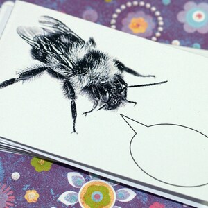 May include: A black and white illustration of a bumblebee with a speech bubble. The bumblebee is drawn in a realistic style with detailed markings on its body.