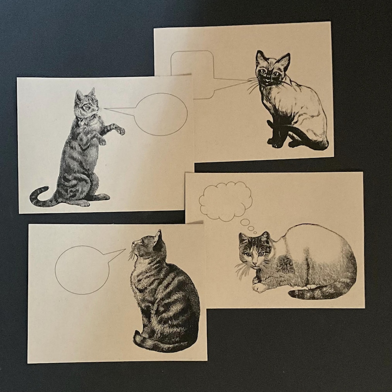 May include: Four blank cards with black and white illustrations of cats with thought bubbles. The cats are in different poses, including sitting, standing, and lying down.