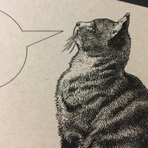 May include: Black and white line drawing of a cat looking up with a speech bubble above its head.