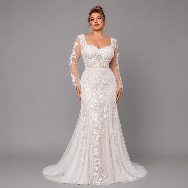 May include: A floor-length white gown featuring long sheer sleeves, a sweetheart neckline, and a structured corset-style bodice. The dress is adorned with intricate white floral embroidery and lace appliqu&eacute;s that extend down the skirt.