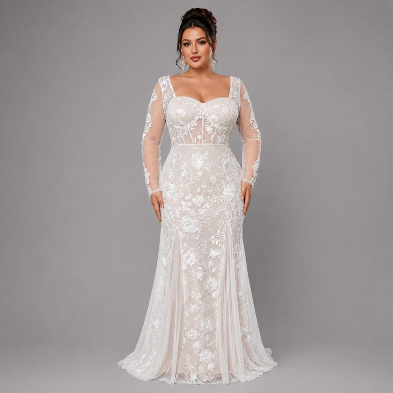 May include: A floor-length, long-sleeved gown featuring a sweetheart neckline and a corset-style bodice. The dress is crafted from a sheer, light-colored fabric adorned with intricate white floral embroidery and sequins throughout the entire garment.