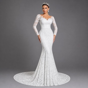 May include: A white lace wedding dress with long sleeves and a mermaid silhouette. The dress features a sweetheart neckline and a long train. The bride is wearing a silver tiara and earrings. The background is a solid gray.