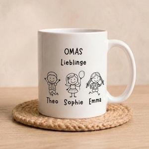 Könnte beinhalten: Ein weißer Keramikbecher mit schwarzen Strichzeichnungen von drei Kindern und dem aufgedruckten Text OMAS Lieblinge, wobei die Namen Theo, Sophie und Emma unter der jeweiligen Kinderfigur auf der Vorderseite des Bechers stehen.