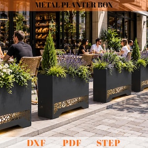 May include: A rectangular black metal planter box featuring a decorative laser-cut geometric pattern along the bottom edge. The planter is filled with green shrubs and purple lavender plants. The text METAL PLANTER BOX, DXF, PDF, STEP is visible.