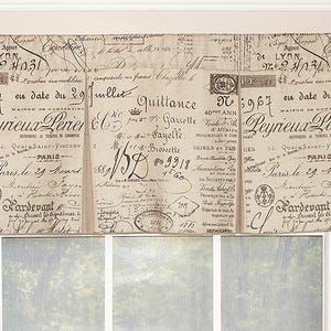 May include: A decorative window valance with a vintage French script design. The valance is divided into three panels, each featuring faded text, stamps, and handwritten elements in black ink on a cream background. The valance is mounted above a window.
