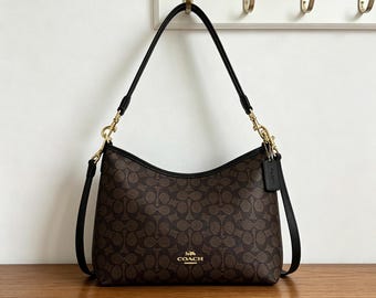 Coach's classic monogrammed shoulder bag, featuring gold-tone hardware, is the perfect everyday work bag for women.