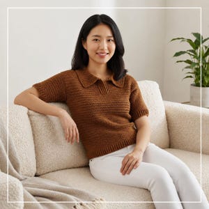 May include: A short-sleeved, brown crochet polo shirt featuring a classic collar, a V-neckline, and ribbed detailing at the cuffs and hem. The garment is constructed with a consistent, textured stitch pattern throughout the body and sleeves.
