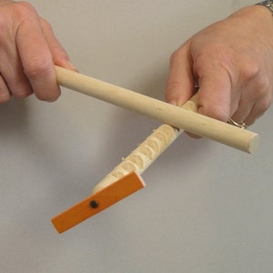 Hooey Stick with ORANGE wooden spinner.  Also called a whimydiddle or gee-haw stick.  A natural wood toy.