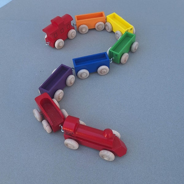Wooden Toy Rainbow Train with red locomotive.