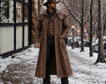 May include: A long brown distressed leather duster coat worn over a matching vest and dark trousers. The outfit includes a wide-brimmed brown cowboy hat and brown leather boots. The coat features a shoulder cape, large front pockets, and metal buttons.