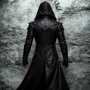 May include: A long, black leather hooded coat with a tailored fit. The coat features a belt at the waist, shoulder accents, and buttoned sleeves. The model is shown from the back, against a textured gray background.