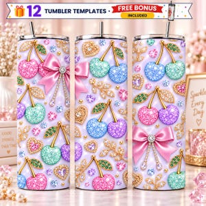 May include: Three cylindrical tumblers featuring a repeating pattern of glittery cherries in pink, blue, and green, gold-toned stems, pink satin bows with rhinestone accents, and small gold heart charms on a light purple background.