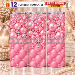May include: Three cylindrical tumblers featuring a pink quilted pattern with embedded crystals, topped with a design of pink pearls, sparkling gems, and heart-shaped accents. A pink bow with a crystal heart sits in the center of the middle tumbler.