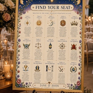 May include: A rectangular wedding seating chart in a gold frame featuring a celestial theme with stars, moons, and tarot-inspired illustrations. The text reads FIND YOUR SEAT, WRITTEN IN THE STARS, BROUGHT TOGETHER IN LOVE, and JANE & JOHN OCTOBER 31, 2026.